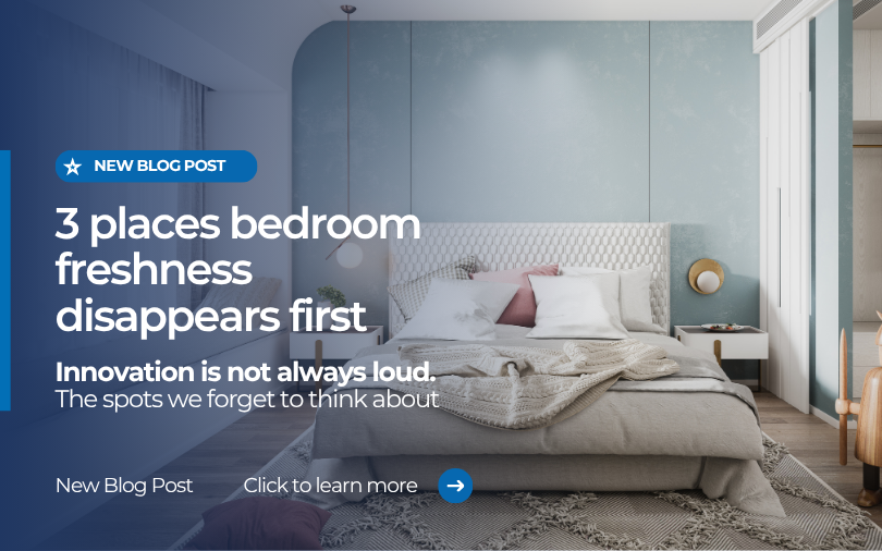 Modern bedroom interior with neatly styled bed and soft blue wall, featuring text about bedroom hygiene and the three places freshness disappears first.